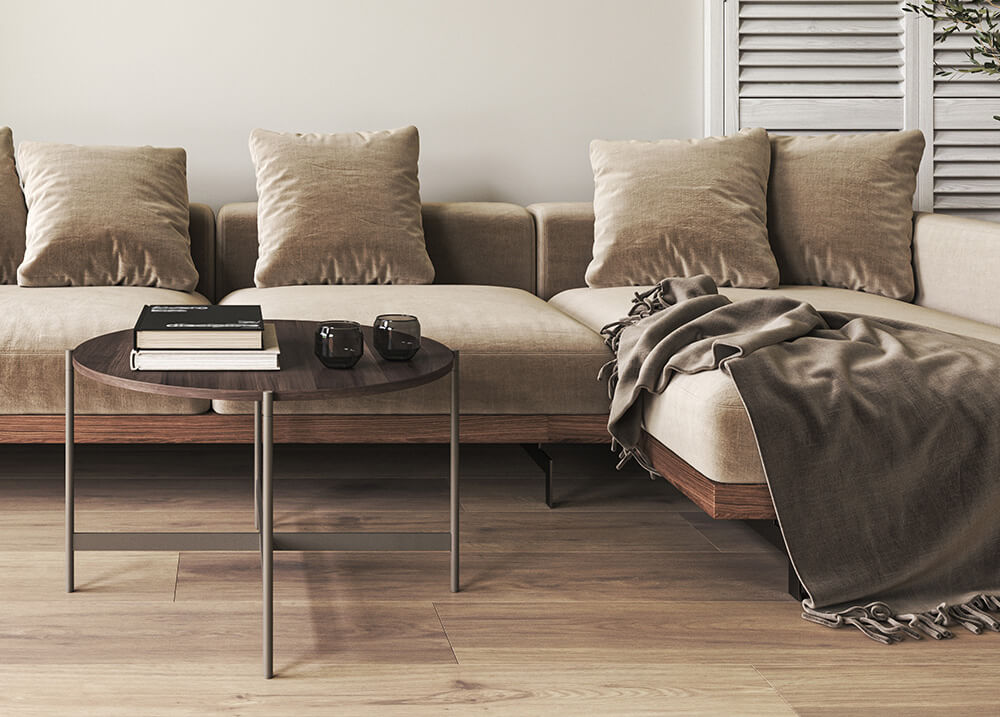Living room with a sofa sculpted glass coffee table and fur throw pillows (Demo)